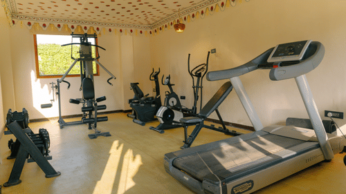 Gym with different kinds of equipment arranged